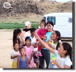 Ann gives the children "bubble toys".